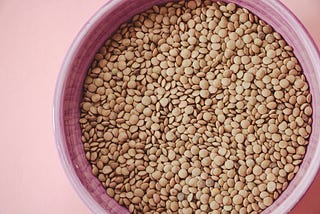 A purple bowl filled with lentils.