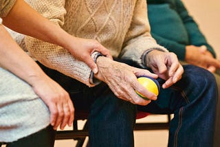 Elderly couple holding hands.