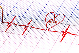 The graphic trace of a heartbeat with a heart shape in it and the word ‘A11y’ inside the heart