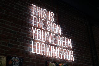A neon sign that says “This is the sign you’ve been looking for”