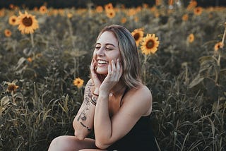Lady in Sunflower field smiling and happy