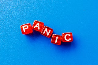 The word panic spelled out in red blocks on a blue background.