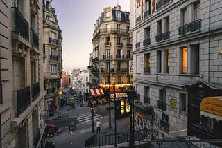 A Parisian street with building buildings and a Métro entrance.