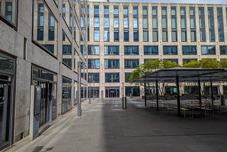 Empty courtyard of a large school building showing rows of windows