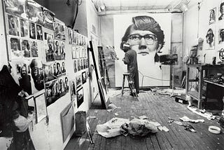 artist in their studio with unfinished painting
