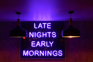 Neon sign with the text “Late Nights, Early Mornings”