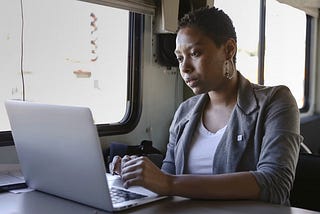 A young woman works on her computer.