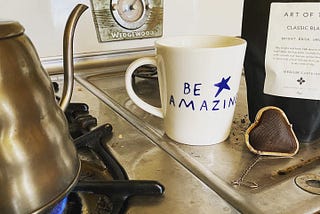 Making tea with mug, infuser, and kettle on a Wedgewood stove