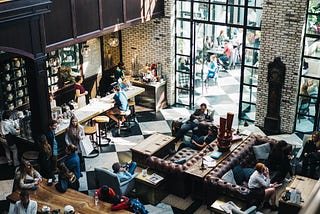 A crowded cafe on a sunny day.