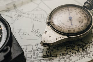 A weathered compass on a map