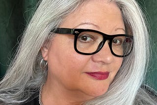 woman with silvery long hair and black glasses / red lipstick