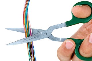 A wire being cut by scissors