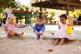 three children in a sandbox