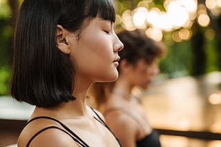 woman close her eyes in mindfulness meditation