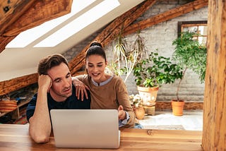 A picture of a couple working from home.