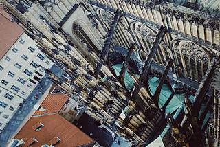 a view from above a very tall and architecturally precise church in Prague