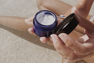 An open jar of moisturiser skincare by Mathilde Langevin