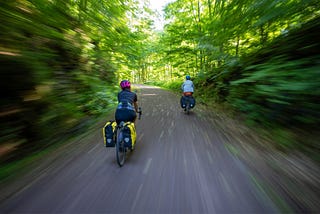 Two people riding bicycles.
