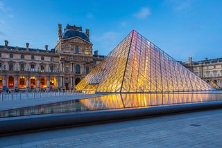 Louvre pyramid in Paris at dusk
