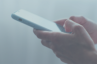 person typing on smartphone