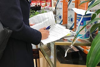 DCWP Inspector writes a violation for price gouging at a store that sells face masks and cleaning wipes.