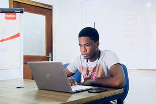 A writer editing a draft on his laptop