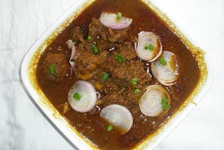 Mutton curry with whole garlic pod