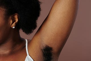 A woman with an unshaven armpit.