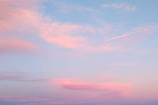 a blue sky with some pinkish clouds