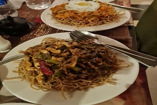 Two Chinese noodles served in plates