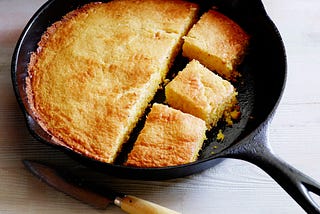Color photo of cornbread in a cast-iron pan