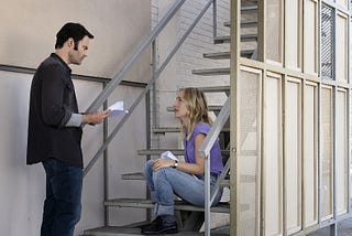 Bill Hader standing, and Sarah Winkler sat on some stairs, reading lines, in the second season of Barry.