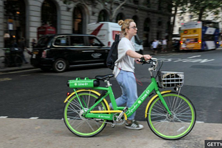 Woman with an e-bike along the street