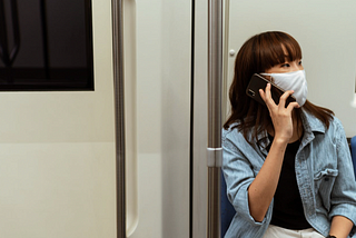 Woman wearing mask talking loud on her smart phone