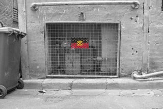 Aboriginal land rights flag cross stitched with yarn onto a steel mesh grid in the laneways of Naarm.