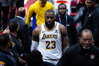 LeBron James heads down a tunnel surrounded by security and police officers after the conclusion of a Lakers game.