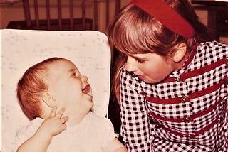 The author as a baby laughing at her older sister.