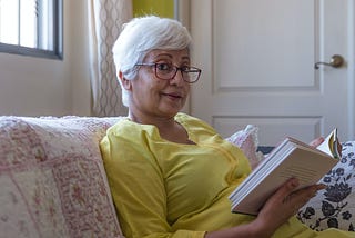 Elderly woman reading a book.