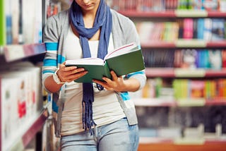 College student reading in a library.