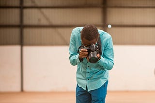 Boateng Sekyere, a photographer, looking through his camera’s viewfinder
