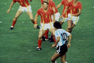 Diego Maradona of Argentina is confronted by Belgium players during the 1982 World Cup