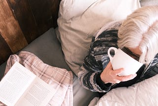 drinking tea in bed with a book