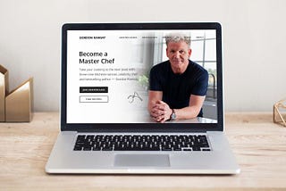 MacBook computer on a table, displaying a redesign of Gordon Ramsay’s website.