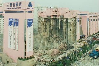 Photo of a collapsed pink building, the Sampoong Mall.