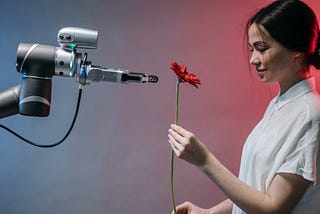Robot giving a red rose to a woman with dark hair