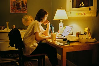 Student studying at night with laptop and planner — productivity tools, student planners, and dorm desk setup inspiration.