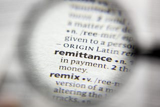 The word “remittance” under a magnifying glass.