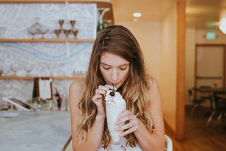 A sexy woman drinks a milkshake before masturbating in a crowded mall food court. A sexy erotica about the mall.