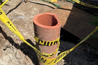 A section of our old clay sewer pipe used to tape off repairs to our house.