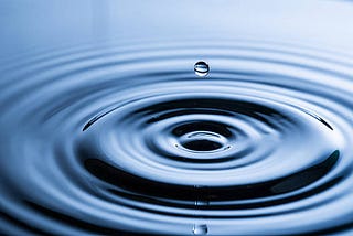 A drop of water causes a ripple effect in a pool of water